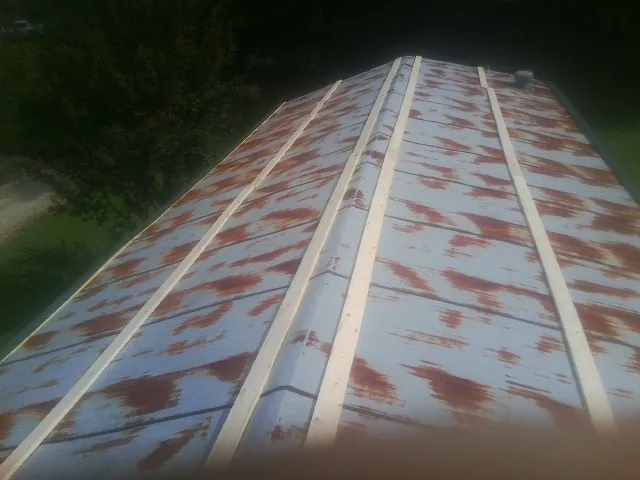 Rusted metal roof panels with new wood purlins before replacement — Storm Damage Roof Repair in Middlesex by Roofing Brothers
